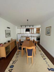 a kitchen and dining room with a table and chairs at Cozy Skopje House in Skopje