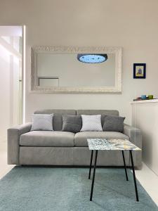 a living room with a couch and a table at Residenza Santi ai Monti in Rome