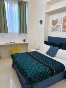 a bedroom with a bed with a blue and green bedspread at Residenza Santi ai Monti in Rome +50 photos