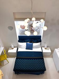 a bedroom with a bed and a chandelier at Residenza Santi ai Monti in Rome