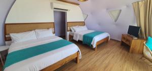Katil atau katil-katil dalam bilik di Malipaya Villas