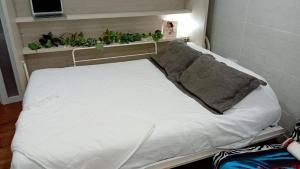un lit d'hôpital avec des plantes sur une étagère dans l'établissement Frida Almuñecar, à Almuñécar