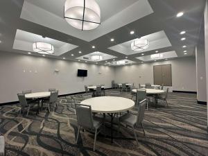 a conference room with tables and chairs and a screen at Best Western Plus Chandler in Chandler