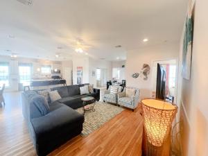 a living room with a couch and a table at Amazing 360 Ocean & Bay Water Views in Freeport