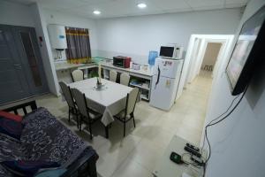 a kitchen with a white table and a white refrigerator at Amor de Finca in General Alvear