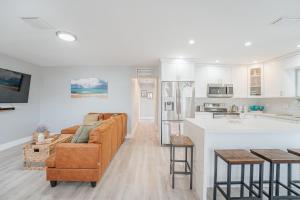 a kitchen and living room with a couch and a table at Home with heated pool close to beach and FLL airport in Fort Lauderdale