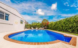 a swimming pool in the backyard of a house at Home with heated pool close to beach and FLL airport in Fort Lauderdale