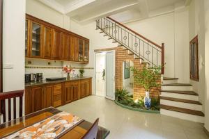 a kitchen with a spiral staircase in a home at Entire 3BR house 3 baths & patio Hoan Kiem Dist in Danang