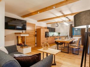 a living room and kitchen with a couch and a table at AlmApARTment Mauterndorf Pichl 7-3 in Mauterndorf