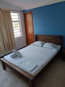 Säng eller sängar i ett rum på Hostel Nirvana San Gil