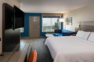 a hotel room with a large bed and a couch at Holiday Inn Express Lewiston, an IHG Hotel in Lewiston