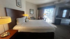 una camera d'albergo con un grande letto e una finestra di Huntington Beach Inn a Huntington Beach