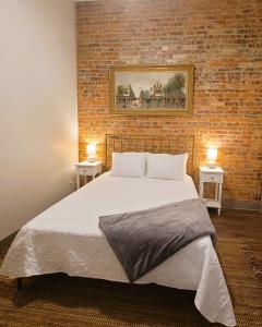 a bedroom with a large bed with two tables at Spacious luxury apt in Historic Downtown - OH Amish country in Millersburg