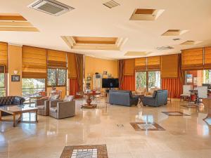 a large living room with couches and tables at Ambassador Hotel Thessaloniki in Plagiárion