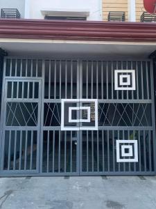 a garage door with three pictures on it at Cagayan De Oro house in Cagayan de Oro
