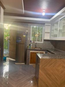 a kitchen with a stainless steel refrigerator and wooden cabinets at Cagayan De Oro house in Cagayan de Oro