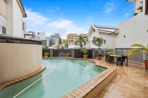 a swimming pool in the backyard of a house at Comfy 2-Bed with Pool and Secure Parking in Brisbane