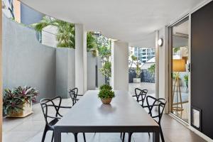 a dining room with a table and chairs at Comfy 2-Bed with Pool and Secure Parking in Brisbane