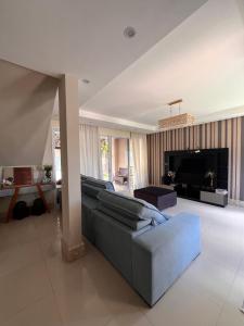 a living room with a couch and a fireplace at Casa Paraiso de Praia in Porto Seguro
