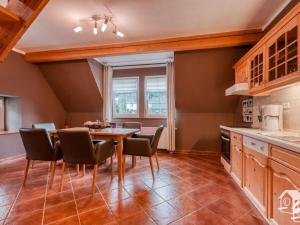 a kitchen with a table and chairs in a room at Maisonette holiday apartment Fichtelberg in Annaberg-Buchholz