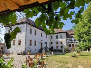 a large white building with chairs in front of it at Inviting apartment in Zell in Oppurg