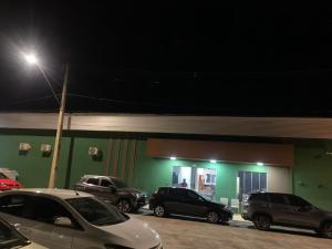 a group of cars parked outside of a building at night at HOTEL XANGRILÁ in Salinas