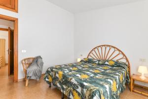 a bedroom with a bed and a chair at Villetta Norsi in Capoliveri +30 photos