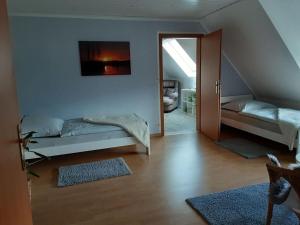 a living room with a bed and a sliding glass door at Apartment in the Eichengrund in Häcklingen