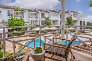 a view from the balcony of a resort with chairs and a pool at Treasure Beach by Elegant Hotels - All-Inclusive, Adults Only in Saint James