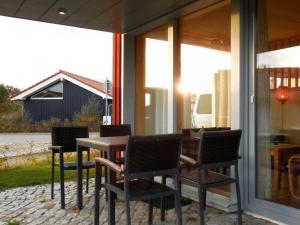 a wooden table and chairs on a patio at Lovely apartment in Immenstadt in Zierow