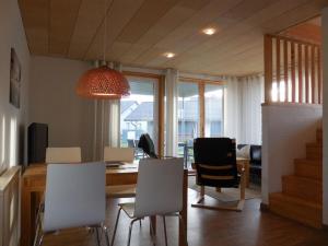a kitchen and dining room with a table and chairs at Lovely apartment in Immenstadt in Zierow