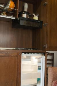 an empty refrigerator with its door open in a kitchen at Lapignagialla in Martina Franca +7 photos
