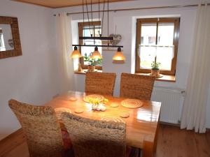 a dining room with a wooden table and chairs at Holiday home in Wilsecker with private terrace 