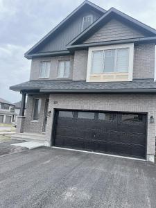 a house with a large garage door in a driveway at Voltage in Ottawa