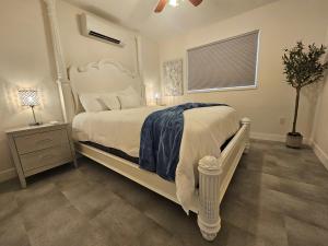 a bedroom with a white bed and a window at La Dolce Vita B and B in Osoyoos
