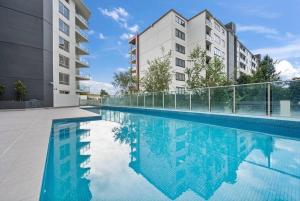 an image of a swimming pool in a building at Serain Apartment on Northbourne Ave Canberra in Canberra