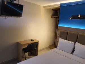 Uma TV ou centro de entretenimento em Hotel Residencial Alfa