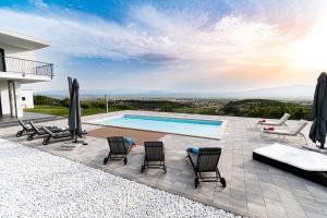 a villa with a swimming pool and patio furniture at Family friendly house with a swimming pool Otok, Zagora - 22669 in Otok