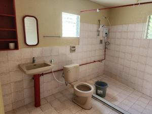a bathroom with a toilet and a sink at Golda Coast Resort - Oslob in Oslob +36 photos