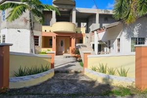 a house with a fence in front of it at Dolphin Villas AXA in Crocus Hill