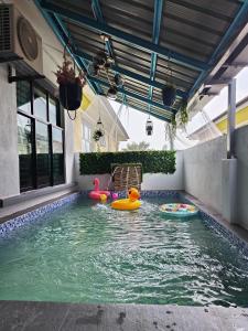 an indoor swimming pool with toys in the water at RUMAH MARYAM PRIVATE POOL DI PANTAI BESERAH in Kuantan +6 photos