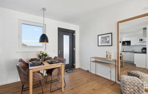 a living room with a table and chairs and a kitchen at Rundumblick in Winterberg