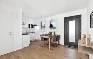 a white kitchen with a table and a dining room at Rundumblick in Winterberg