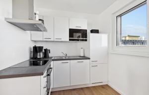 a white kitchen with a sink and a window at Rundumblick in Winterberg