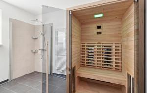 a sauna in a bathroom with a glass shower at Rundumblick in Winterberg +11 photos