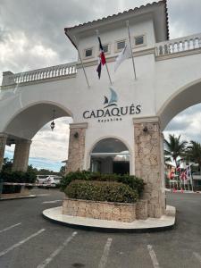 a carolis hotel with a sign in a parking lot at Apartamento Cadaques Bayahibe in Mata Chalupe
