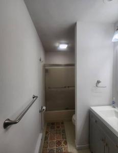 Poconos Retreat في بوشكيل: حمام مع دش ومرحاض ومغسلة