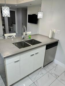 a kitchen with a sink and a counter top at Lovely lake view apartment downtown Calgary one bedroom fully furnished in Calgary