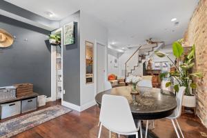 a dining room with a table and white chairs at Columbia Heights Home METRO + Shopping + Parking in Washington