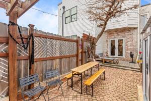 a backyard with a wooden fence and benches at Columbia Heights Home METRO + Shopping + Parking in Washington